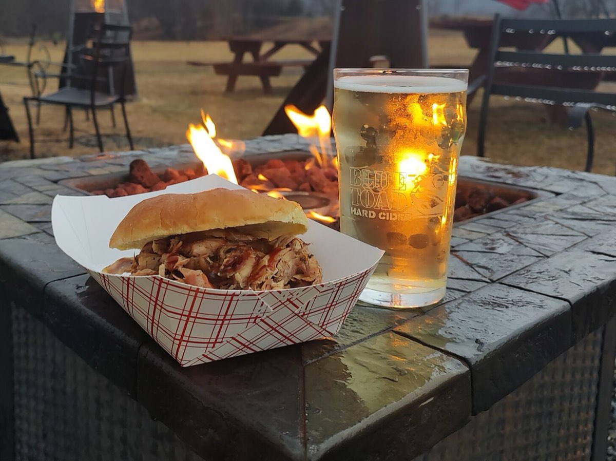 A BBQ Beast pulled-pork sandwich stacked high on a plate at Blue Toad Cidery