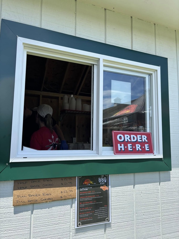 The BBQ Beast order window with the menu board above it
